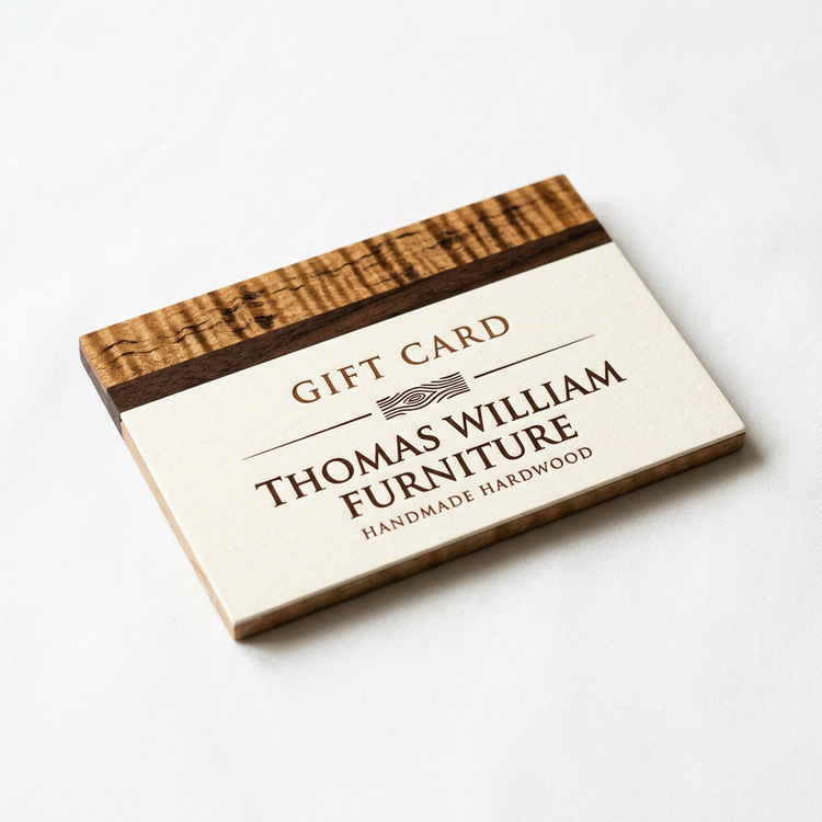 Thomas William Furniture gift card with a cream face and a tiger maple and walnut edge