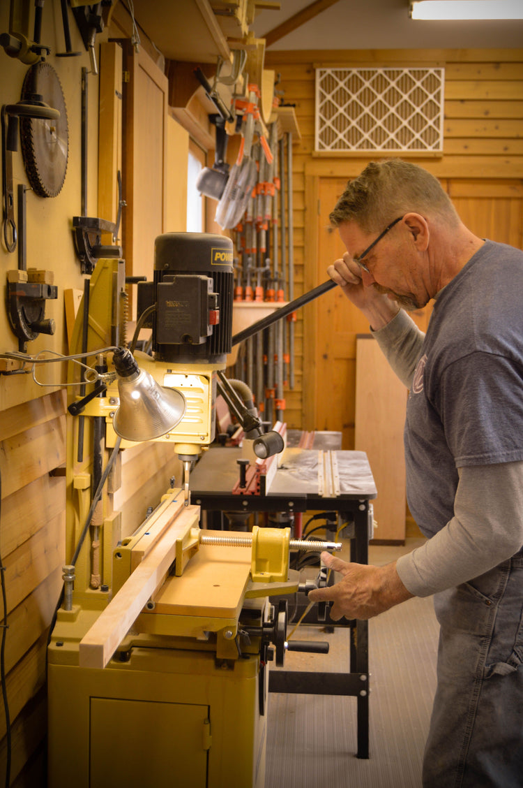 Tom cutting joinery at his mortising machine